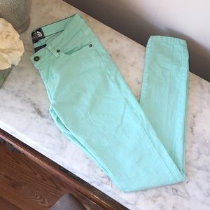 The North Face mint green skinny jeans.